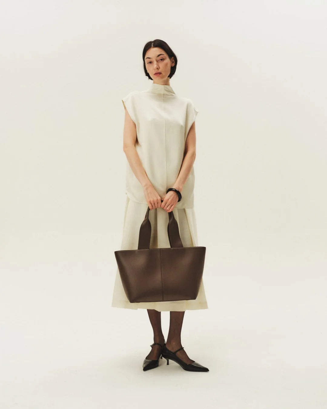 Woman Carrying Uni Tote Bag Dark Brown – Luxurious Faux Leather Tote for University Girls & Working Women Pakistan