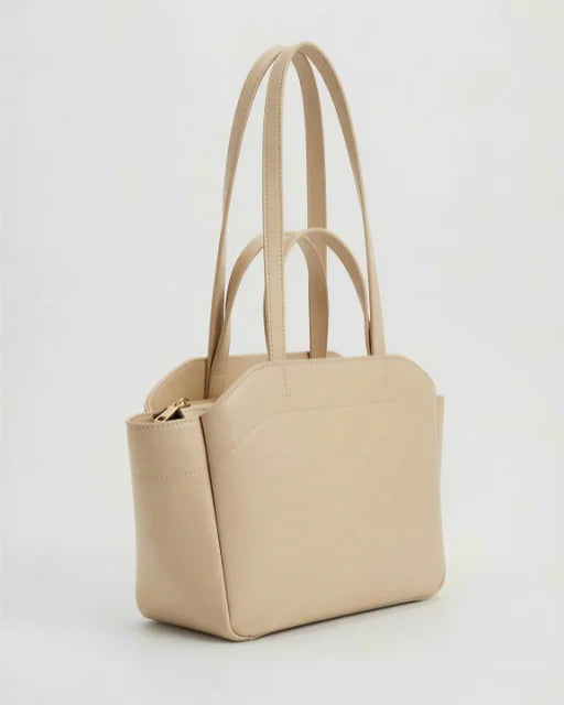Side angle of Zara Bag Beige — wing-flared panel with zip-top detail