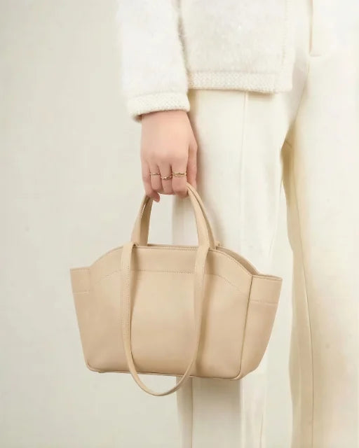 Zara Bag Beige held by short hand loops — hand-carry view