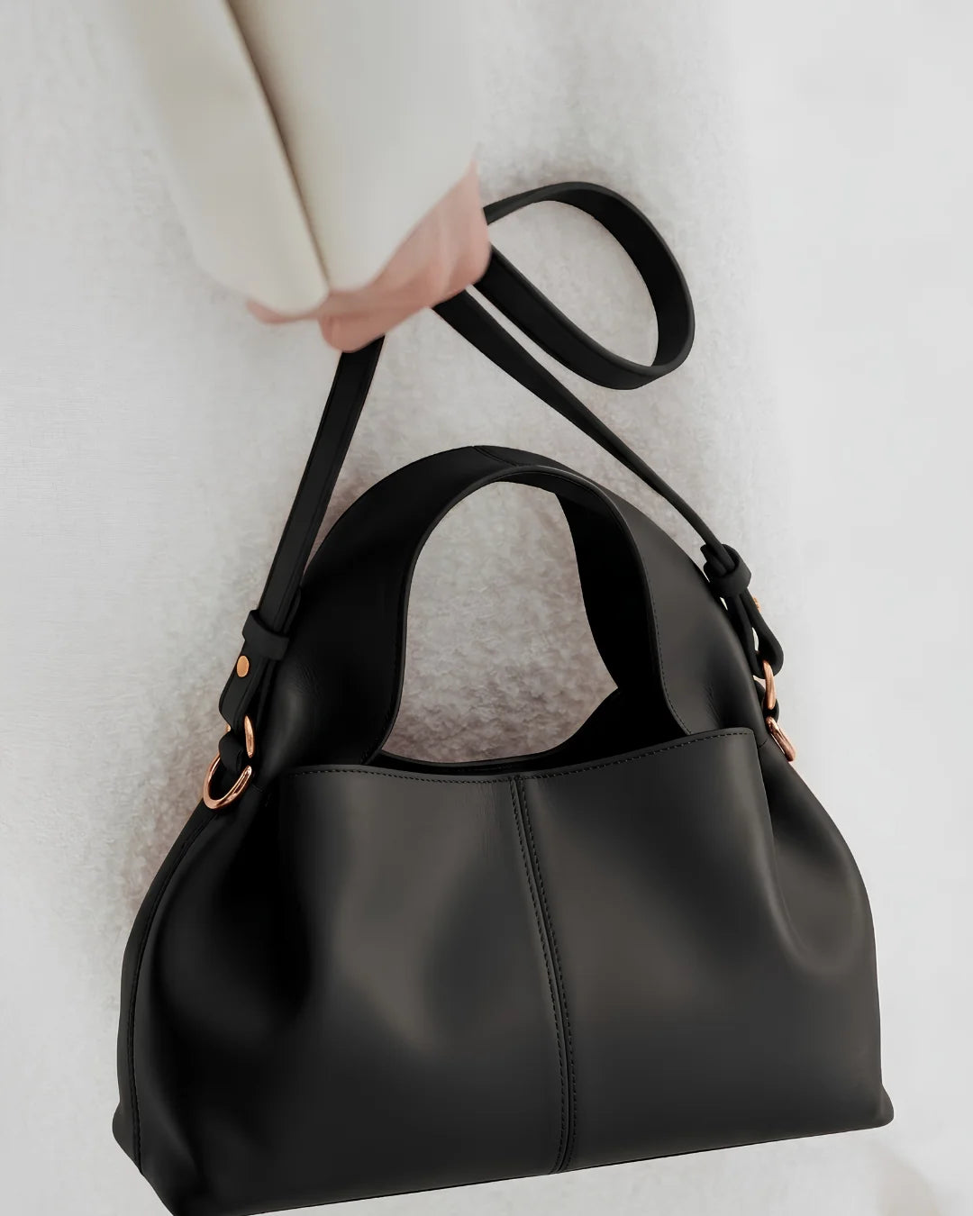 Black leather handbag held by a woman in Pakistan - The Haven Collection by My Light
