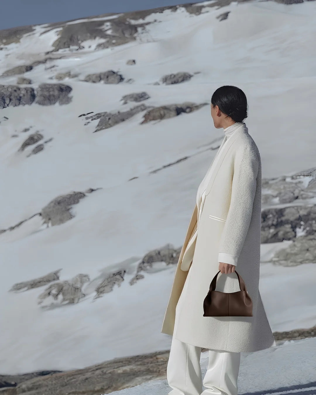 Woman holding a premium brown leather shoulder bag from The Haven Collection by My Light