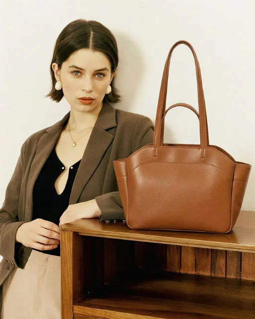 Zara Bag Brown – wing tote on a wooden table, lifestyle shot